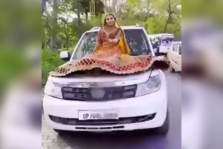 VIDEO: Bride sits on bonnet of a moving car during wedding celebrations, gets fined