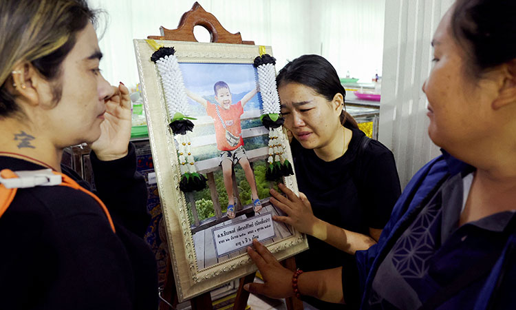 Flowers and toys at funeral for Thai school bus fire victims