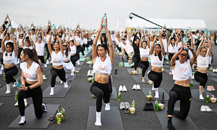 'Feel like a beautiful bird:' Hundreds do yoga on Thai airport runway