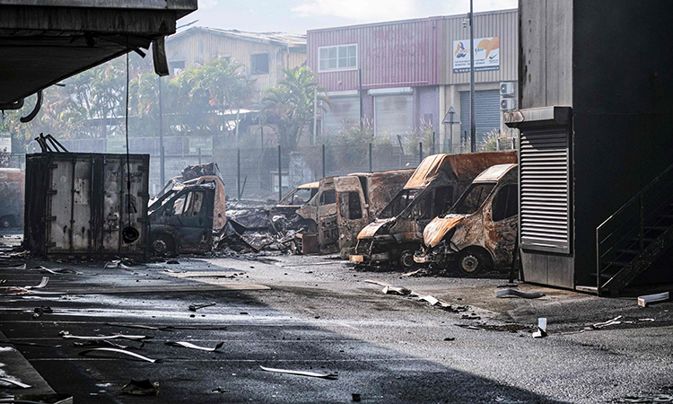 Schools, cars burn in New Caledonia ahead of Macron visit