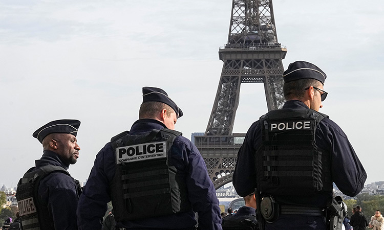 French police arrest three after five coffins draped in national flags left at Eiffel Tower