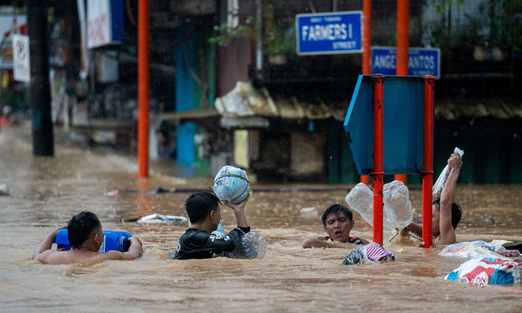 Taiwan prepares for a strong typhoon that worsened monsoon rains in the Philippines, killing 13