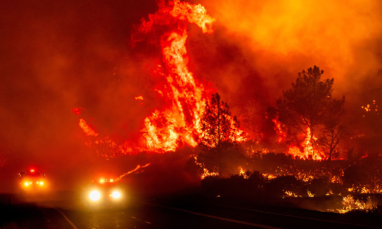 California’s largest wildfire explodes in size as fires rage across US West