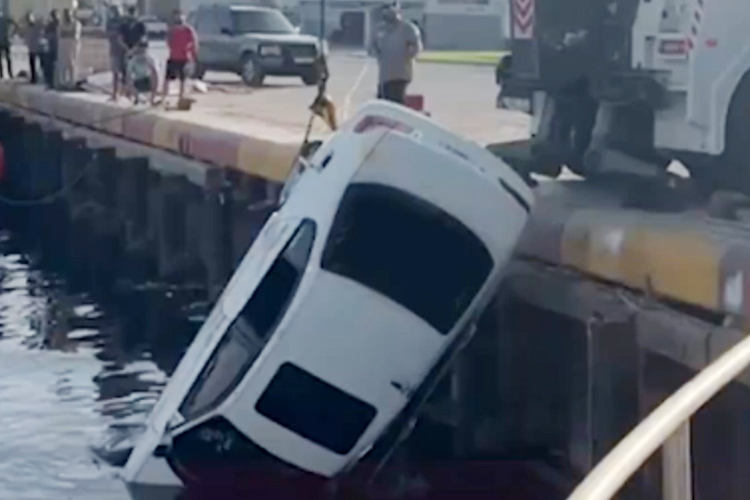 Two young men escape death as car falls off pier in Jaddaf